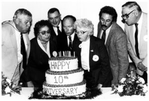 People blowing out candles on a cake