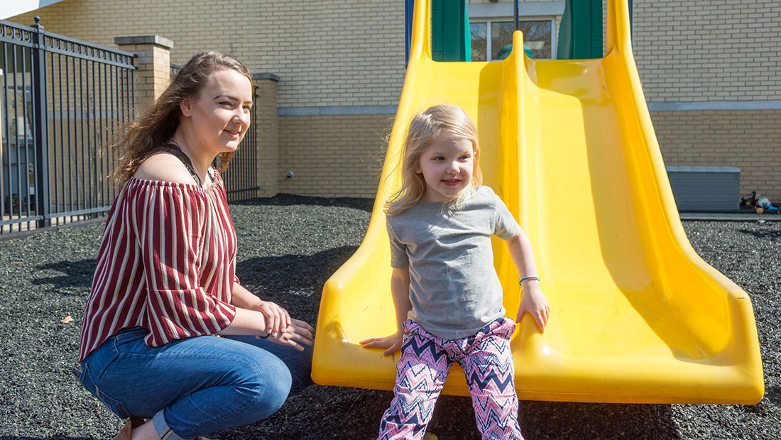 woman on child on playground