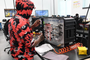 student working on a piece of equipment