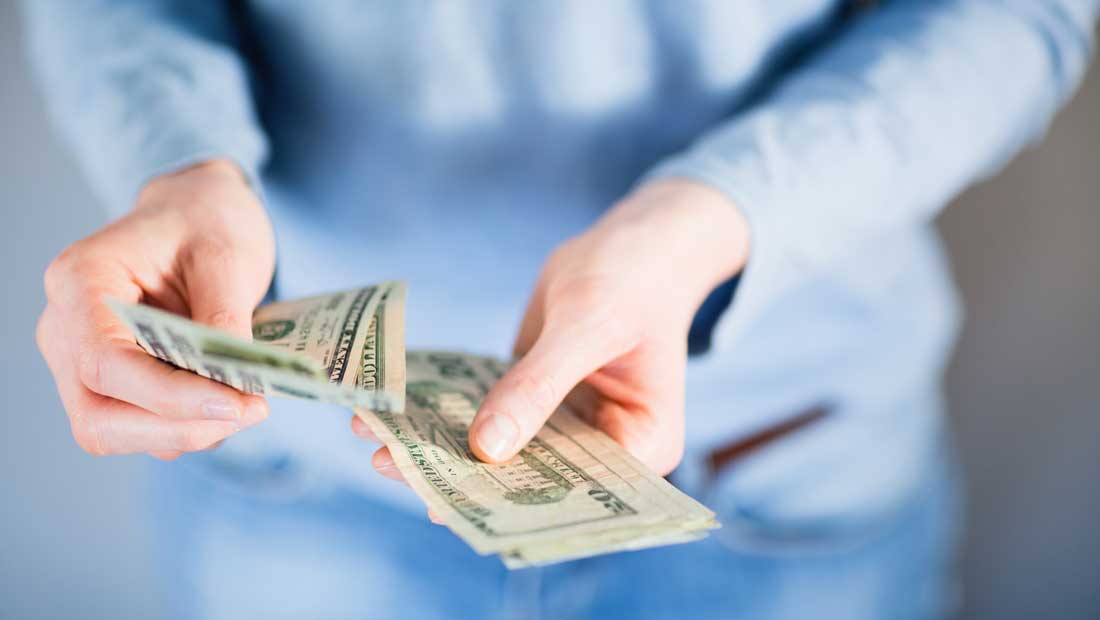 Two hands holding money