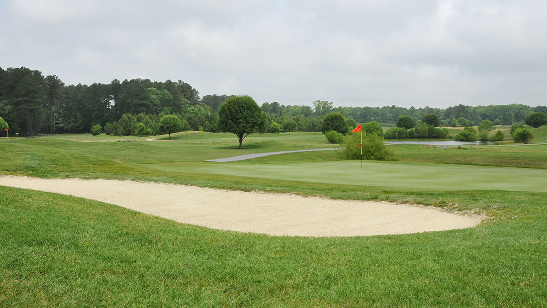 Golf course with a red flag at the hole