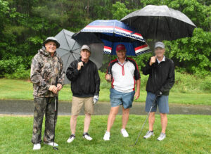 golf team with umbrellas