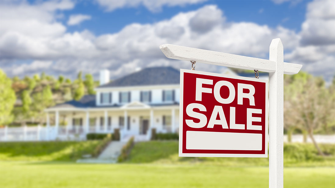 House with a for sale sign